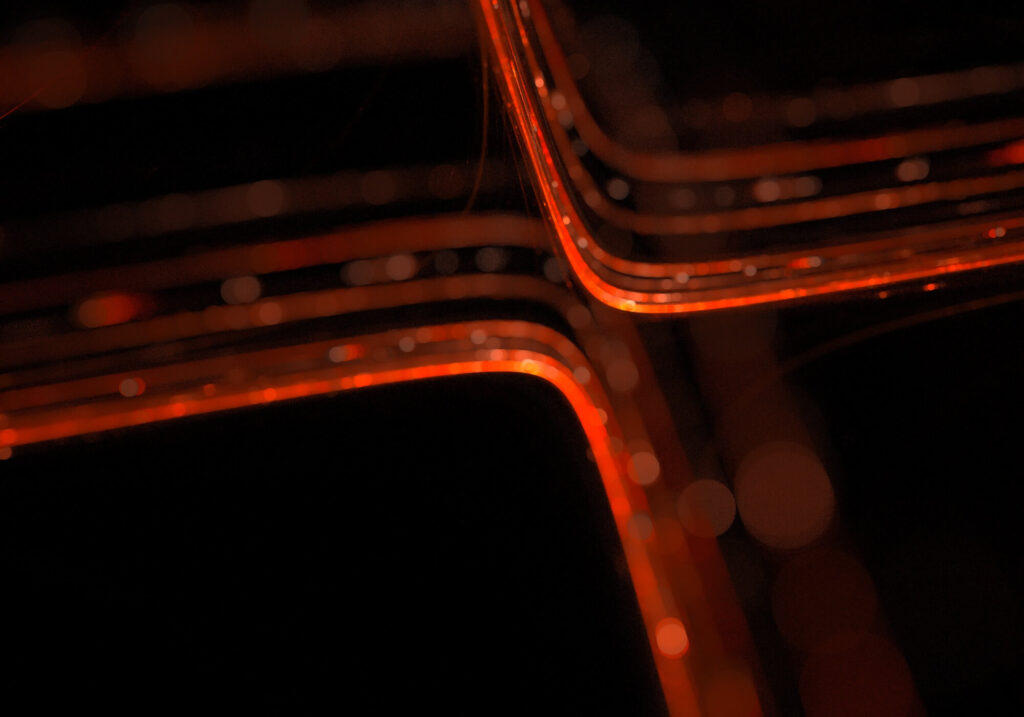 Abstract amber light trails representing digital infrastructure and design logic for LiveFuse Creative.