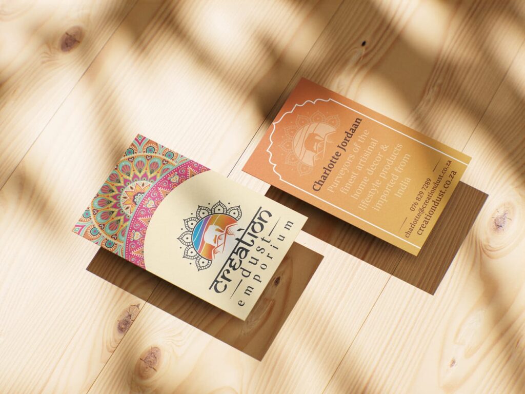 Front and back view of Creation Dust business cards featuring a colorful mandala pattern on one side and contact details with a gold gradient on the other.
